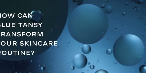 Blue Tansy oil drops in a blue background, highlighting its transformative potential for skincare routines. Blue Tansy visibly calms, heals, and revitalizes skin, and why it might be the perfect addition to your beauty regimen.