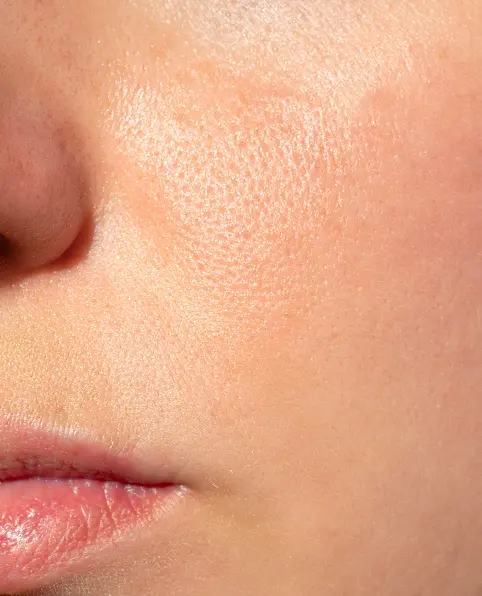 Close-up of a smooth, healthy cheek and lips showing clear skin texture with a natural, subtle glow. The tone is fresh and radiant after using aveseena gentle gardenia face gel cleanser