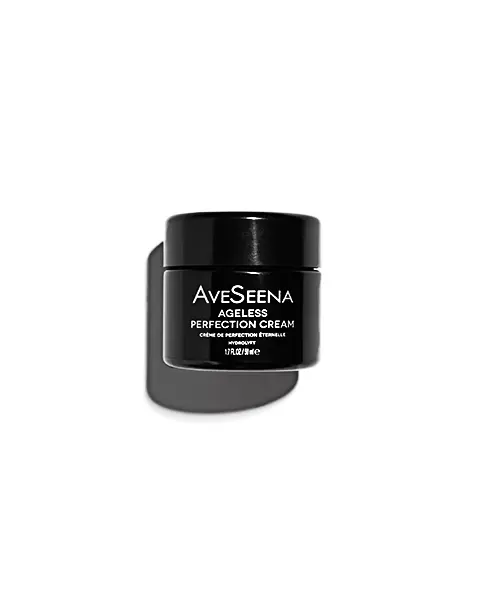 A black jar of AveSeena Ageless Perfection Cream with white text, casting a soft shadow on a white background. The design is sleek and modern.