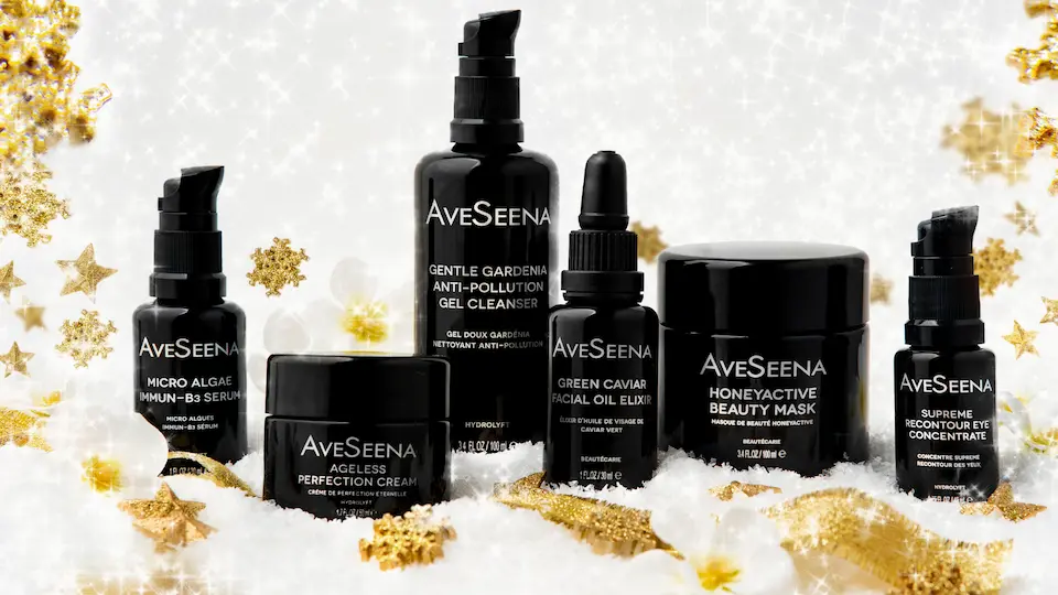 2-3 AveSeena cleanser, serum, moisturizer, oil products laid out on a white marble surface