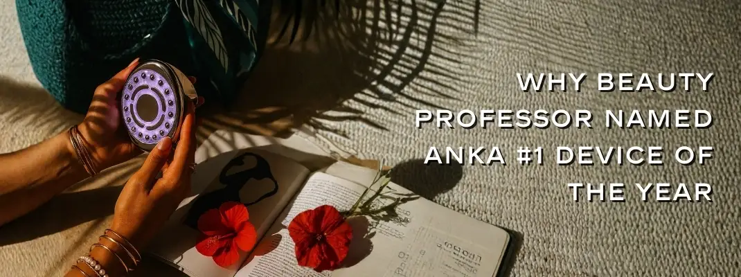 Hands holding a glowing beauty device above an open book with two red flowers. Text reads, "Why Beauty Professor Named Anka #1 Device of the Year."