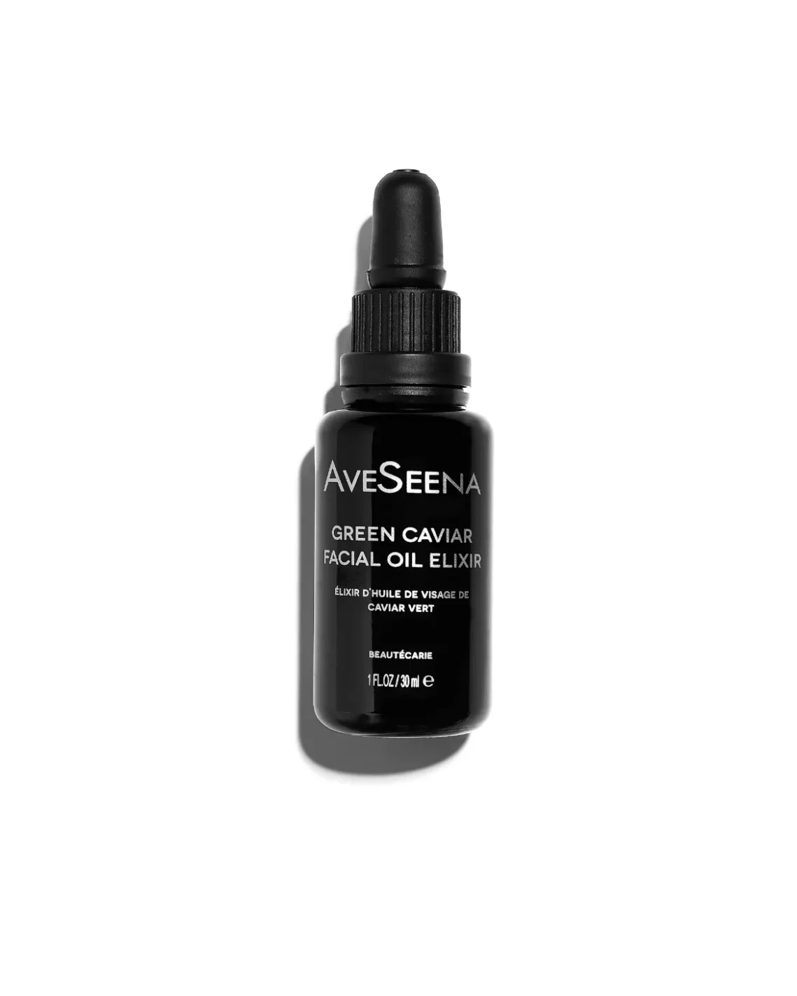 facial oil elixir bottle on a white surface