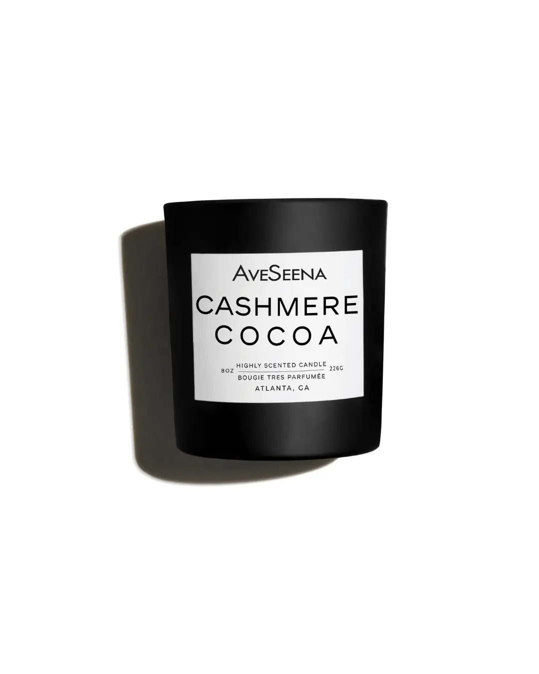cashmere cocoa candle laying on white surface