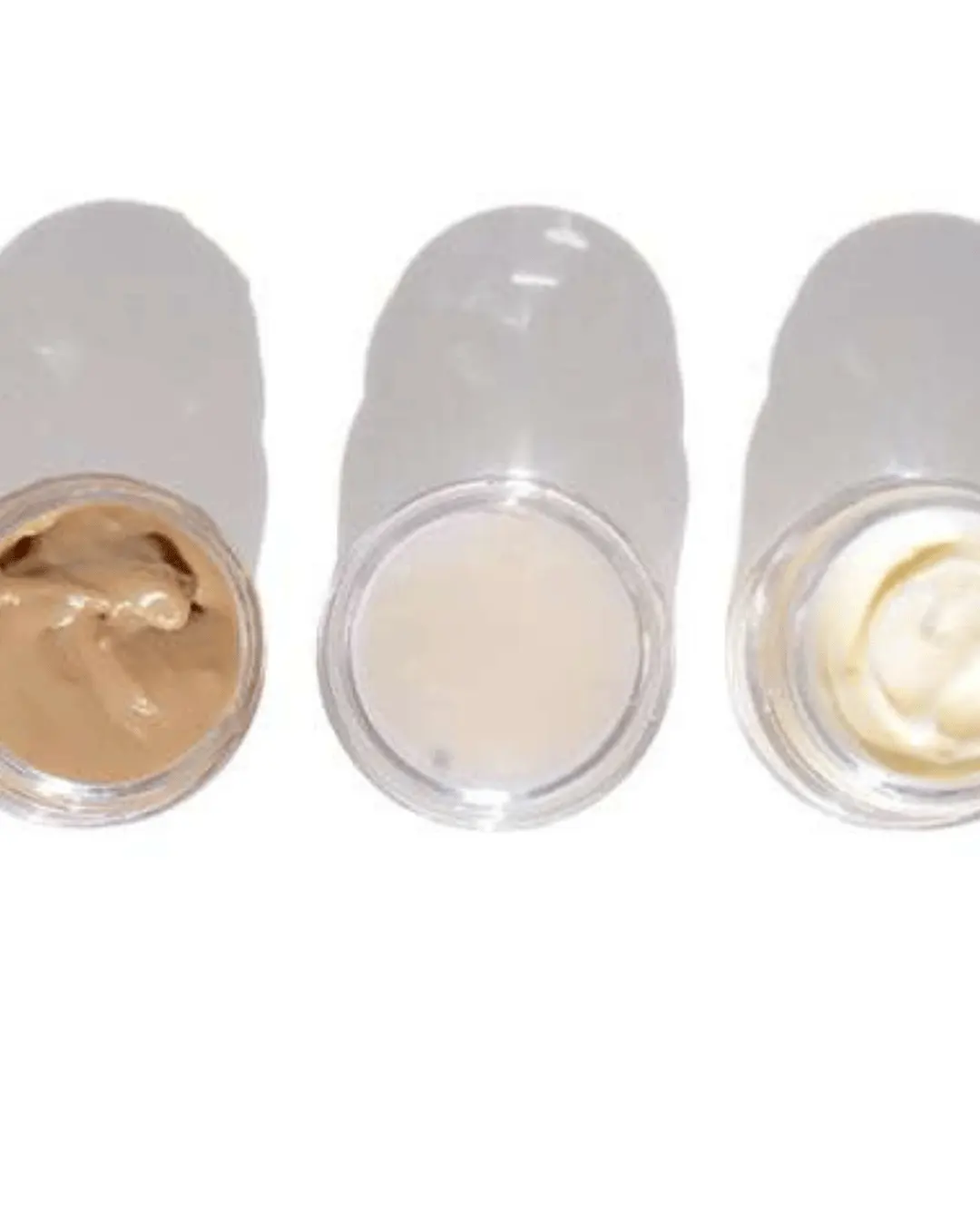 3 skincare sample jars open over white surface