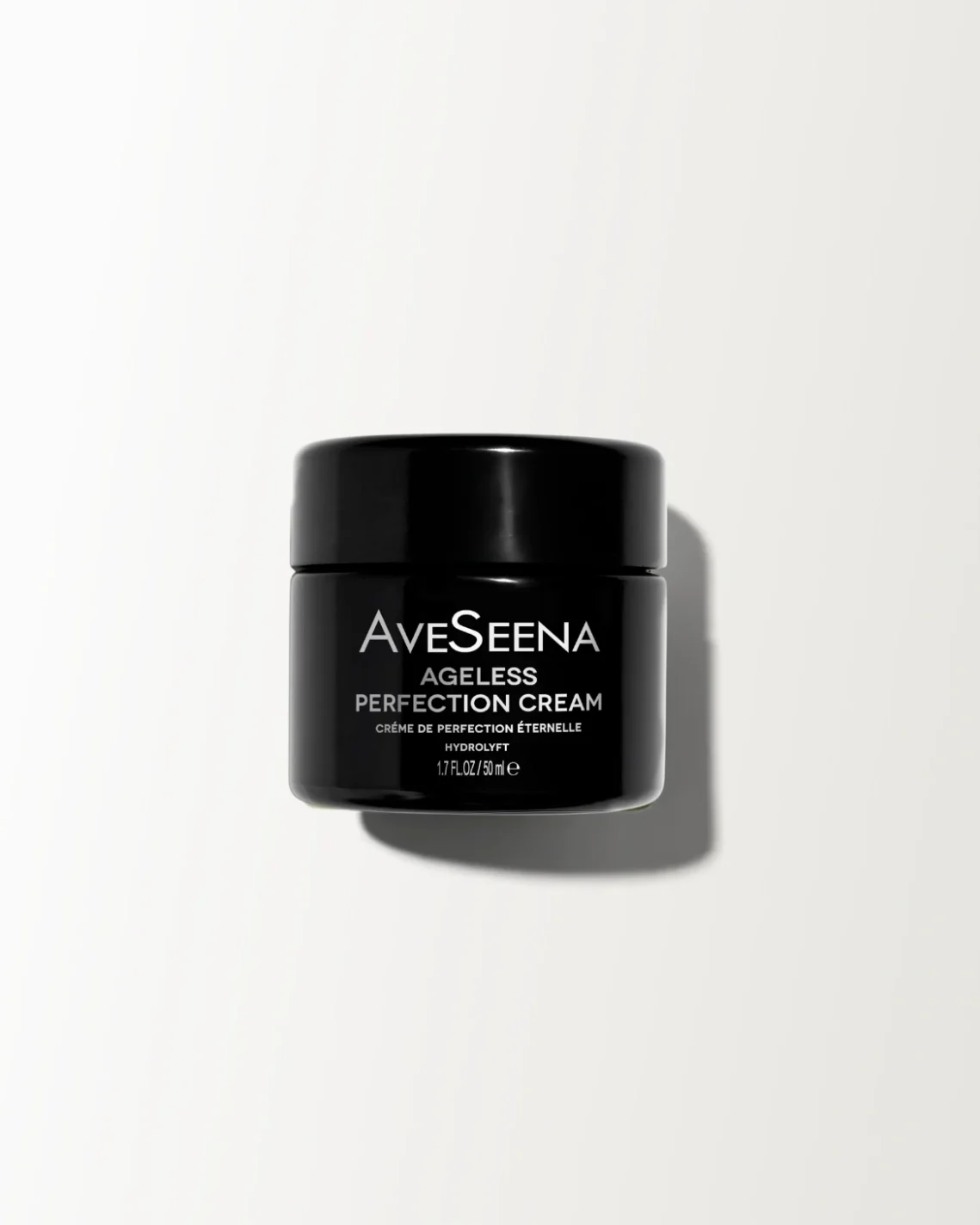 ageless perfection cream jar on a white surface